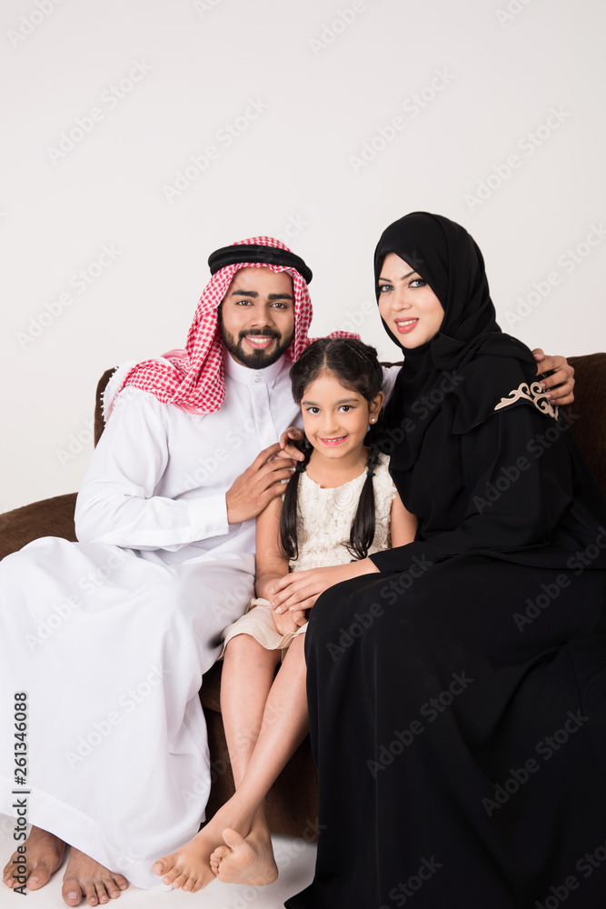 Arab family sitting on sofa chair at home