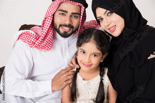 Arab family sitting on sofa chair at home
