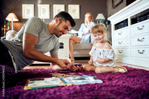 Father playing puzzles with female child