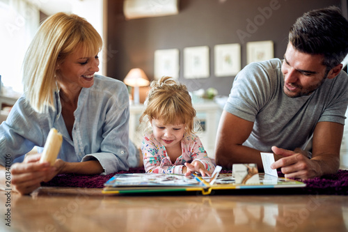 Happy family with cute kid playing