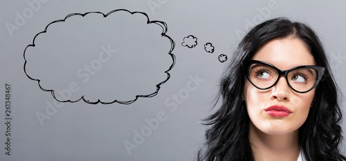 Blank speech bubble with young businesswoman in a thoughtful face