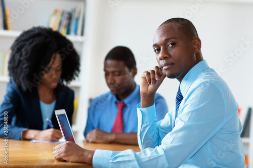 Smart african american financial advisor with business team