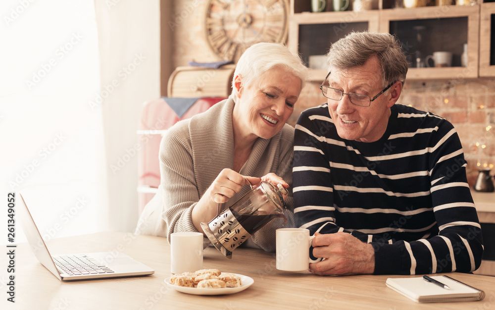 Happy senior couple drinking tea in kitchen Happy senior couple drinking tea in kitchen