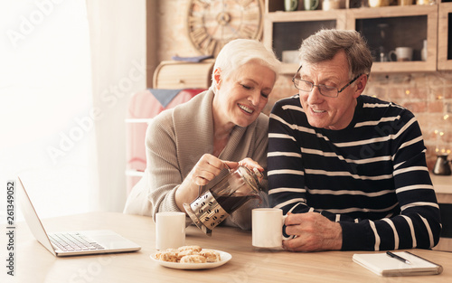 Happy senior couple drinking tea in kitchen © Prostock-studio