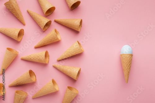 Waffle cones and easter egg on pink surface