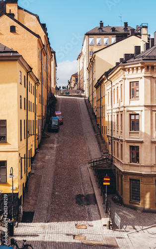 Steep and narrow cobblestone street with old buildings in Stockholm Sweden