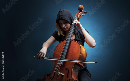 Lonely cellist composing on cello with nothing around
