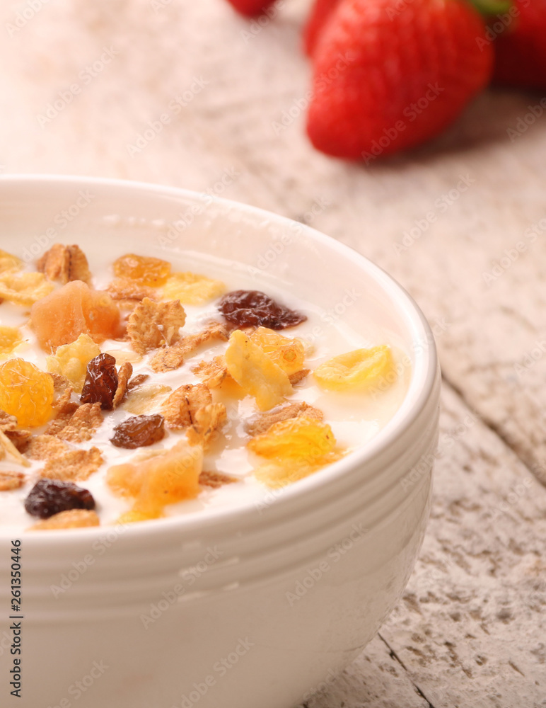 Bowl of yogurt with strawberries and granola muesli, over a white wood background. Bowl of yogurt with strawberries and granola muesli, over a white wood background.