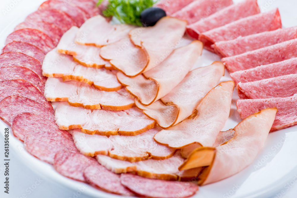 sliced sausage and meat on a plate for restaurant menu
