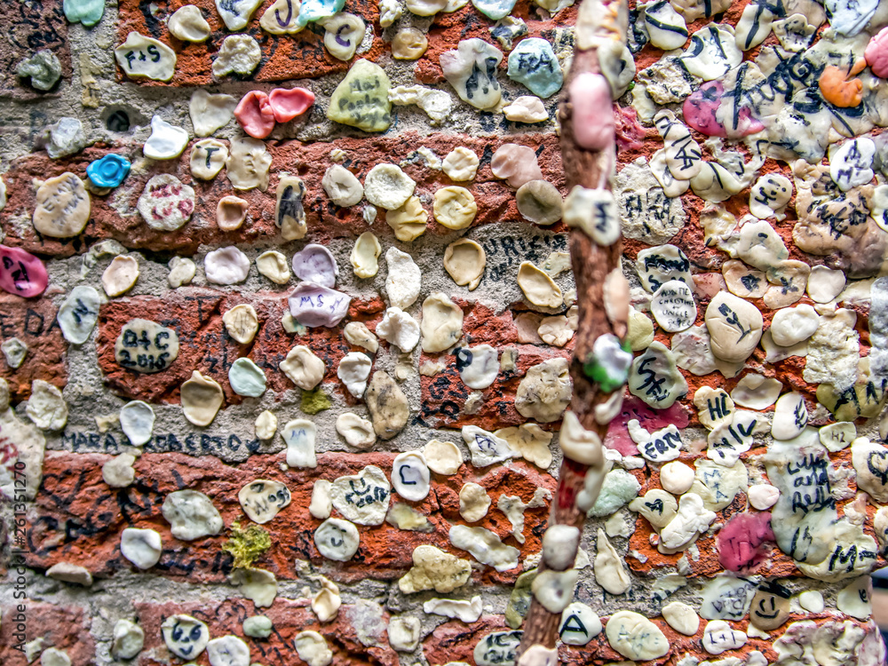 Brick wall covered with used chewing gum