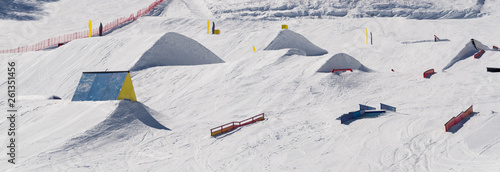 Tableau sur toile Snowpark with ski ramps, kickers, rails for big air jumping, jibbing, etc