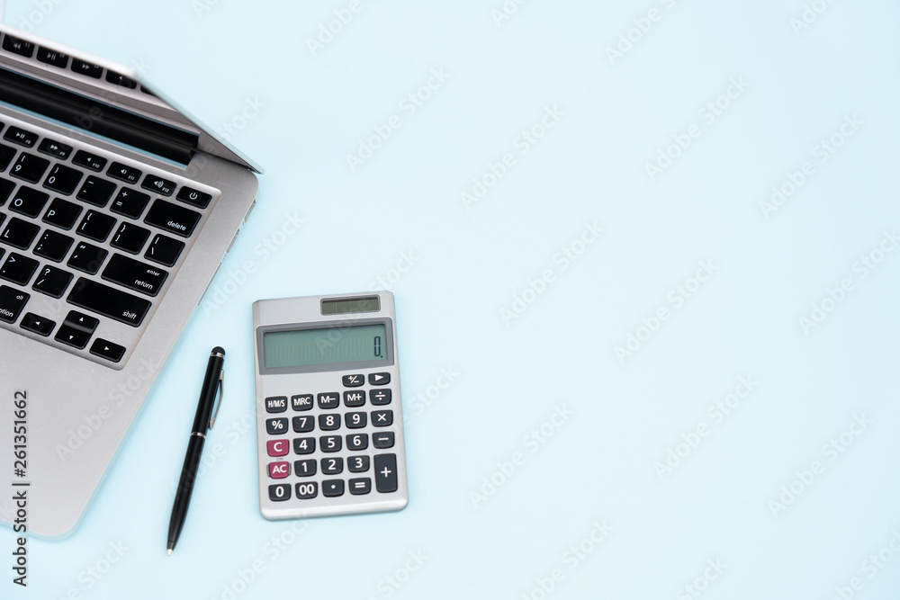 Flat lay, top view office table desk. Workspace with calculator, black pen , laptop on the indigo blue background.Copy Space for text,Empty Blank to word.Business Finance,Education Technology Concept. Flat lay, top view office table desk. Workspace with calculator, black pen , laptop on the indigo blue background.Copy Space for text,Empty Blank to word.Business Finance,Education Technology Concept.