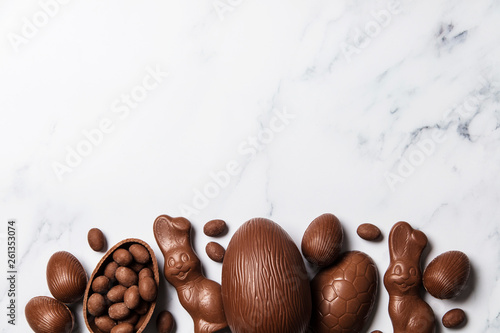 Wall Mural Chocolate easter eggs and bunnies on a marble background