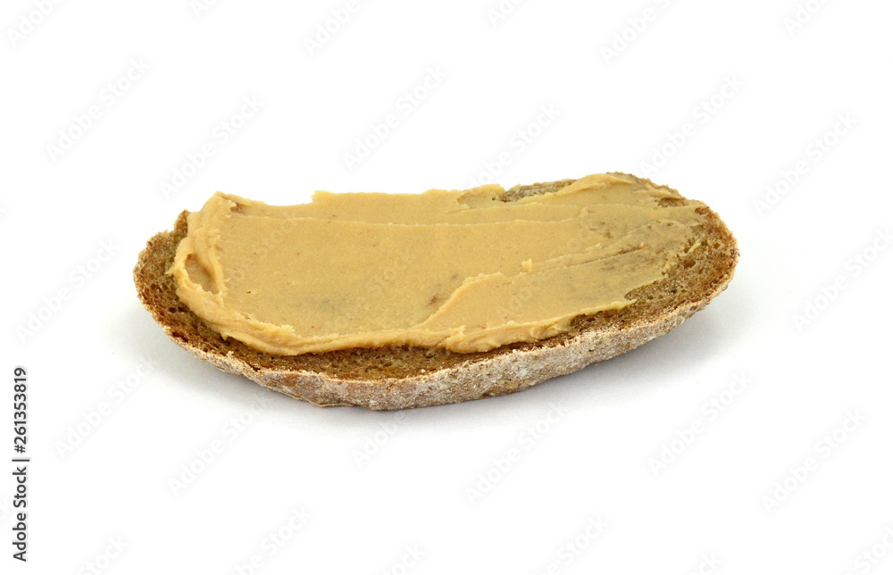Peanut butter on a slice of homemade multigrain bread. Peanut butter on a slice of homemade multigrain bread.