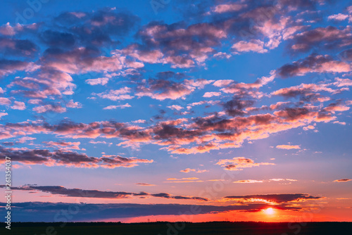 Sunset Sunrise Over Field Or Meadow. Bright Dramatic Sky And Dark Ground. Countryside Landscape Under Scenic Colorful Sky At Sunset Dawn Sunrise. Skyline