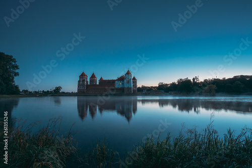 Mir, Belarus. Mir Castle And Lake During Early Summer Morning Time. Cultural Monument, UNESCO World Heritage Site. Famous Landmark And Popular Destination