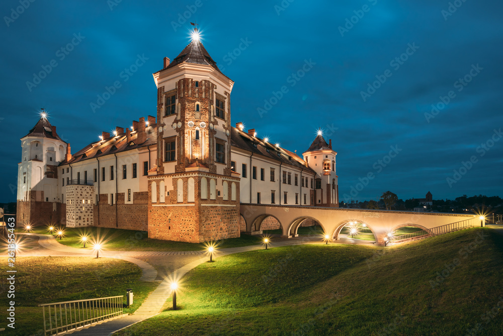 Mir, Belarus. Castle Complex Mir In Evening Or Night Illumination. Cultural Monument, UNESCO World Heritage Site. Famous Landmark And Popular Destination In Night Llight Lighting