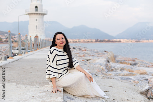 Solo female traveller sitting near the lighthouse