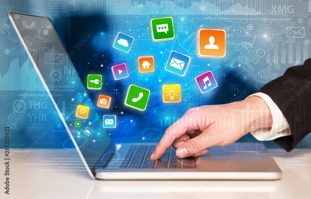 Hand using laptop with bouncing colorful application and global reports and graphs concept
Hand using laptop with bouncing colorful application and global reports and graphs concept