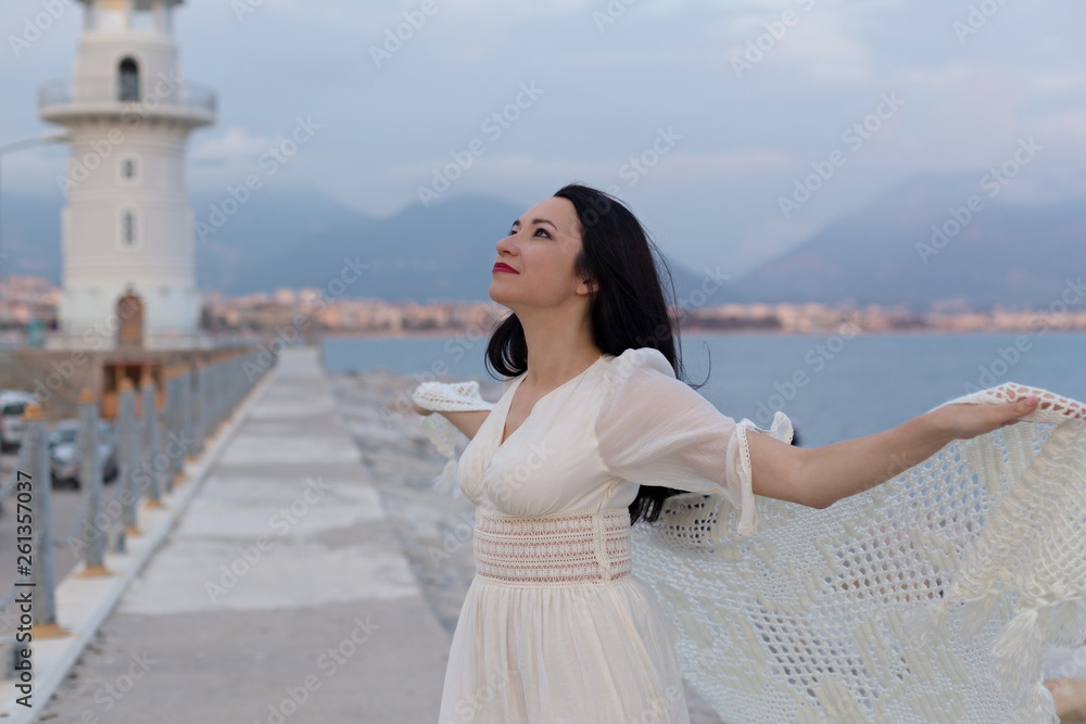 Portrait of beautiful romantic female near the lighthouse Portrait of beautiful romantic female near the lighthouse