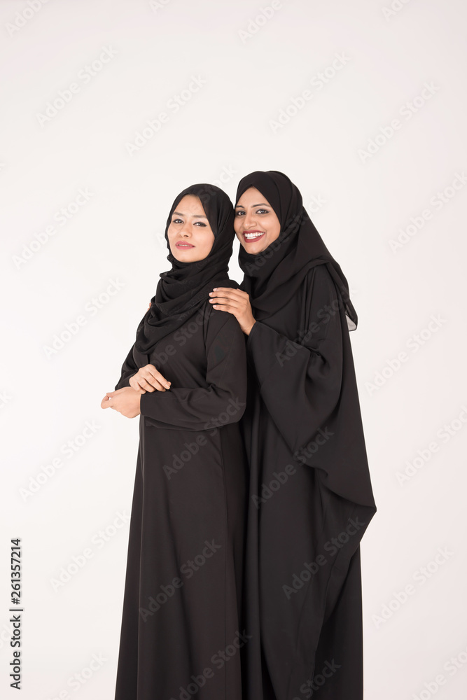 Arab women in traditional dress standing on white background Arab women in traditional dress standing on white background