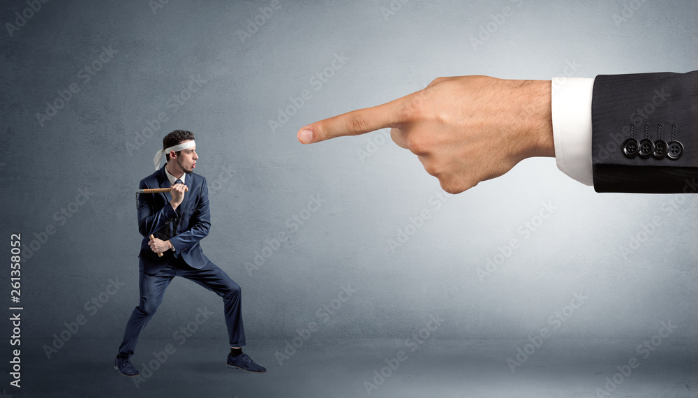 Small karate man fighting with big hand Small karate man fighting with big hand