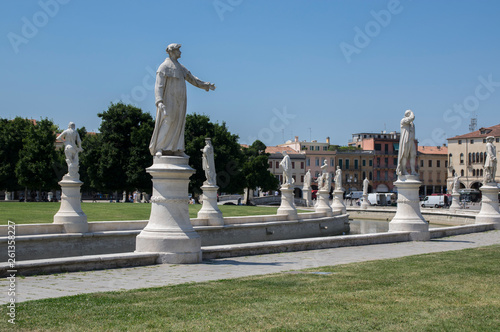 Beautiful summer day on Prato della Valle square with water canal. Amazing italian sculptures.
