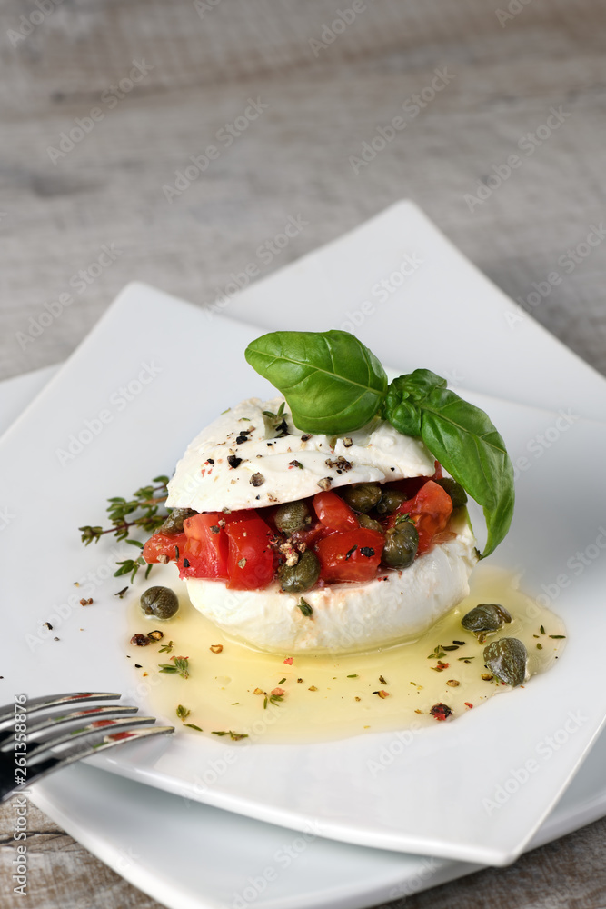 Mozzarella stuffed tomatoes with capers