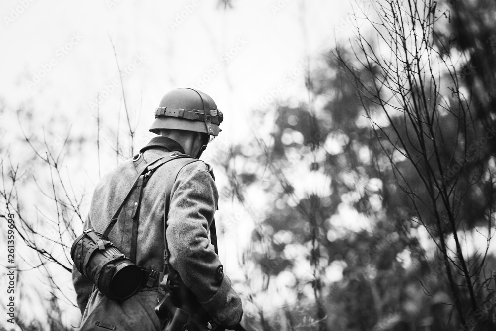 Foto de Single Re-enactor Dressed As German Wehrmacht Infantry Soldier In  World War II Walking In Patrol Through Autumn Forest. WWII WW2 Times. Photo  In Black And White Colors do Stock