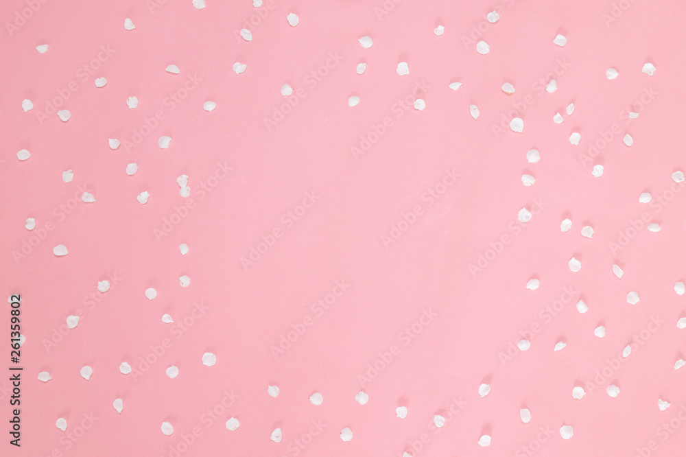 Flower petals on pastel pink background. Flat lay, top view, copy space