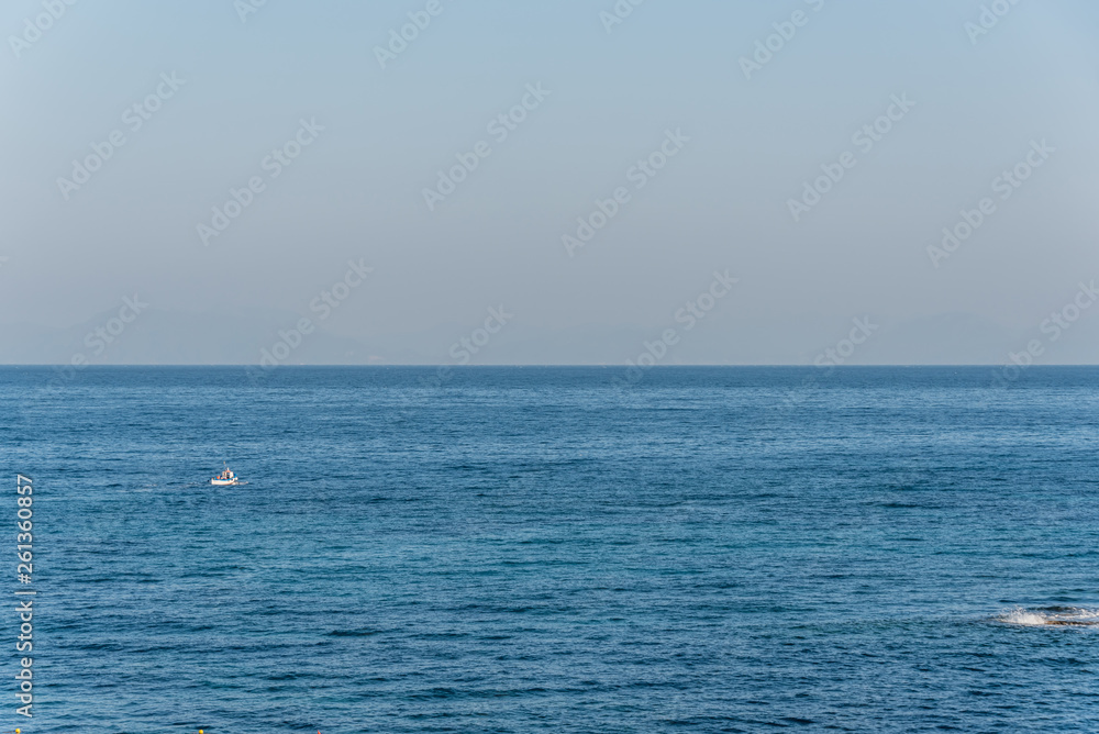 Tiny Fishing Boat on the Blue Italian Mediterranean Sea on a Clear Sunny Day