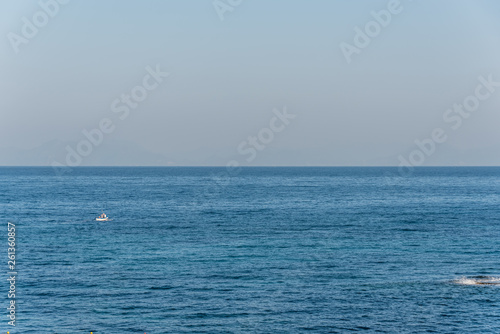 Tiny Fishing Boat on the Blue Italian Mediterranean Sea on a Clear Sunny Day