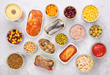 Canned food on stone background, top view