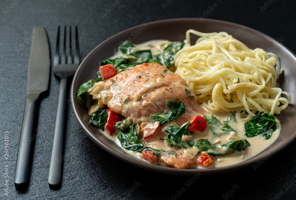 Salmon baked in cream sauce with spinach and bel pepper. 
