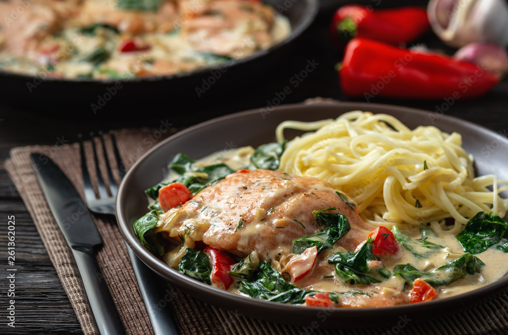 Salmon baked in cream sauce with spinach and bel pepper. Salmon baked in cream sauce with spinach and bel pepper.