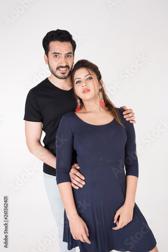 young couple together posing on white background