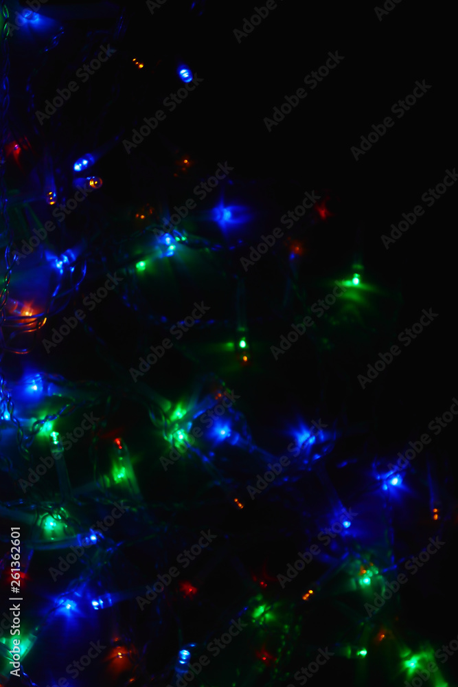 Colored lights (garland) in the dark. Bokeh effect Festive illumination. Colored lights (garland) in the dark. Bokeh effect Festive illumination.