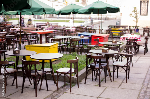 an outdoor Playground  a summer caf  . restaurant tables on the street
