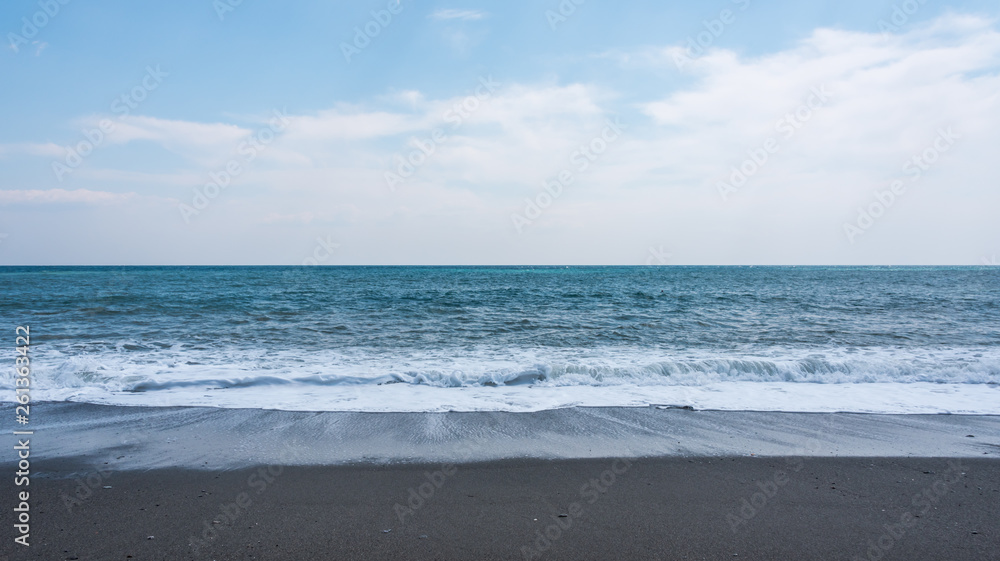 Volcanic Black Sand Beach and Blue Ionian Sea in Sicily