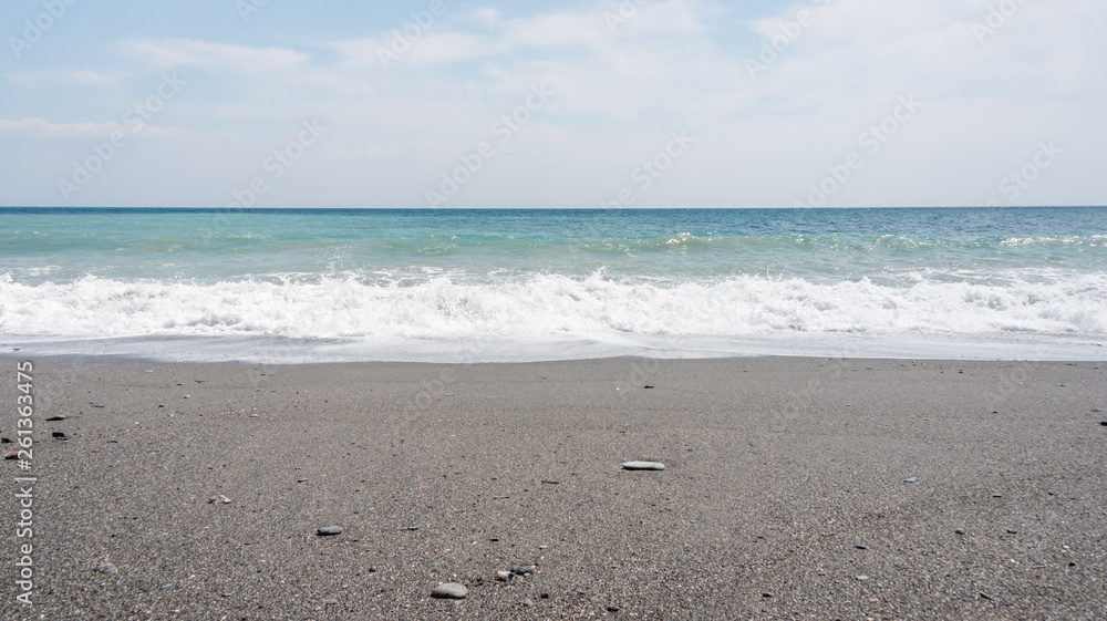 Volcanic Black Sand Beach and Blue Ionian Sea in Sicily Volcanic Black Sand Beach and Blue Ionian Sea in Sicily
