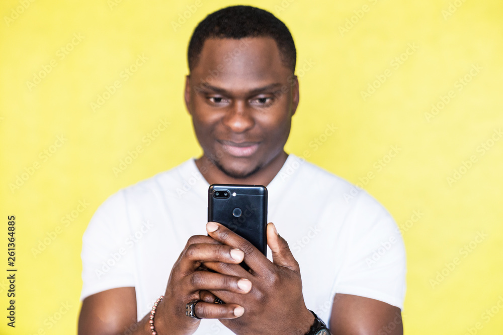African American man taking pictures on a smartphone. African American man taking pictures on a smartphone.