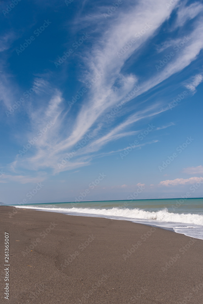 Cloudscape and Volcanic Black Sand Beach and Blue Ionian Sea in Sicily Cloudscape and Volcanic Black Sand Beach and Blue Ionian Sea in Sicily