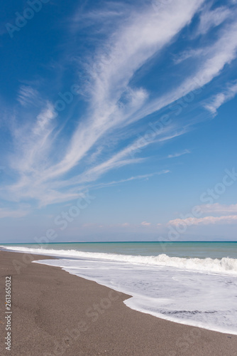 Cloudscape and Volcanic Black Sand Beach and Blue Ionian Sea in Sicily