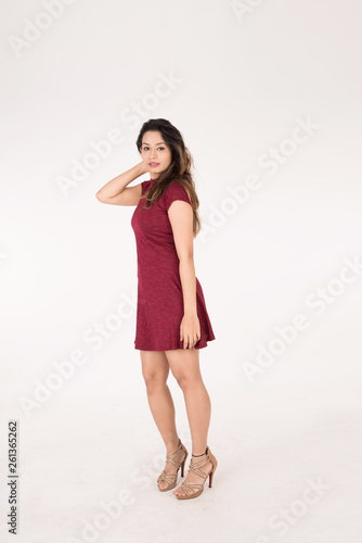 Pretty young female posing on white background © Mahmoud Rahall