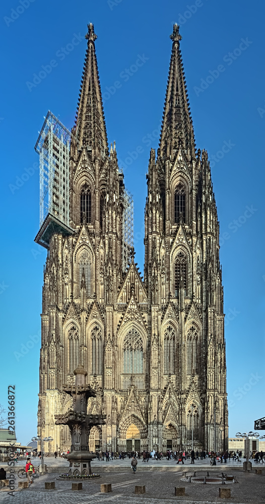 Western facade of the Cologne Cathedral in evening, Germany. Construction of the Cathedral began in 1248. Currently it is the tallest twin-spired church at 157 m (515 ft) tall.