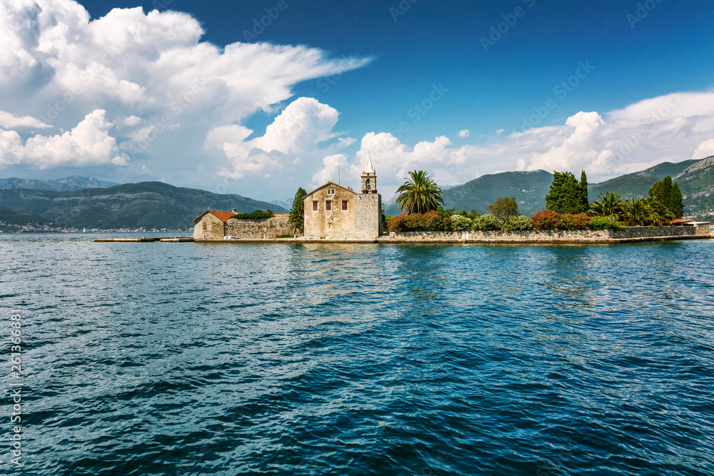 A small island in the Adriatic Sea with an old house and beautiful nature. Sunny day.