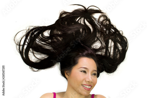 Closeup portrait of happy asian women lying on ground with black long hair. acting smile, fun,