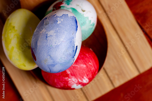 Set of painted Easter eggs in container on table photo