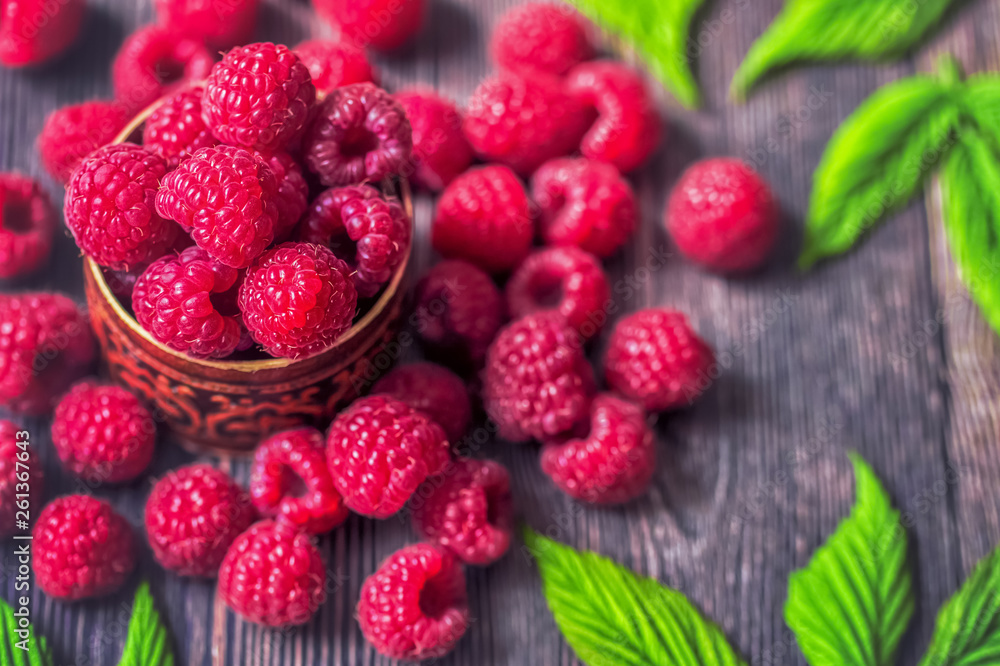 raspberry berries close-up. background with raspberry in wooden bowl on table. raspberry berries close-up. background with raspberry in wooden bowl on table.