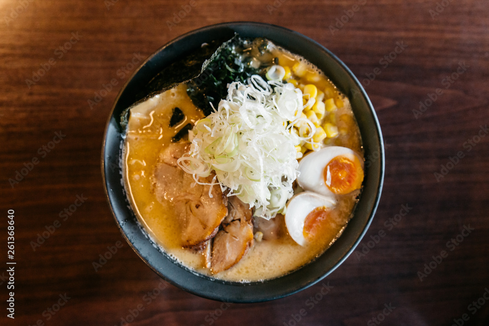 Top view of Ramen Pork Bone Soup (Tonkotsu Ramen) with Chashu Pork, Scallion, Sprout, Corn, Dried Seaweed and boiled eggs. Top view of Ramen Pork Bone Soup (Tonkotsu Ramen) with Chashu Pork, Scallion, Sprout, Corn, Dried Seaweed and boiled eggs.